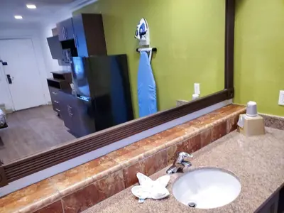 a bathroom with a sink and a large mirror at Studio 6-National City, CA - Naval Base San Diego in National City