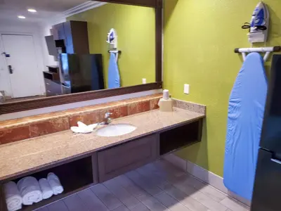 a bathroom with a sink and a large mirror at Studio 6-National City, CA - Naval Base San Diego in National City
