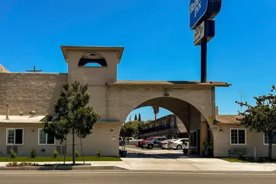 a building with an archway next to a parking lot at Rodeway Inn National City San Diego South in National City