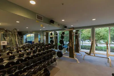 a gym with lots of dumbbells and a lot of windows at Grand Pacific Palisades Resort in Carlsbad