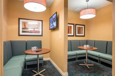 a waiting room with green chairs and tables at Residence Inn San Diego Sorrento Mesa/Sorrento Valley in Sorrento