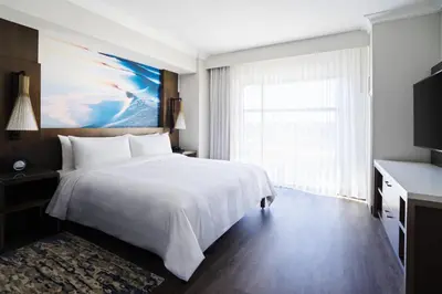 a bedroom with a large white bed and a window at San Diego Marriott Del Mar in San Diego