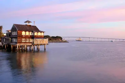 a house on a dock in the water with a bridge at Marriott Marquis San Diego Marina in San Diego