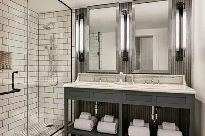 a bathroom with a sink and a shower at Lido House, Autograph Collection in Newport Beach