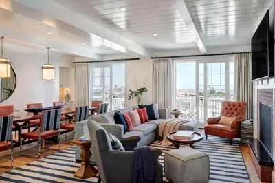 a living room with a couch and a table at Lido House, Autograph Collection in Newport Beach