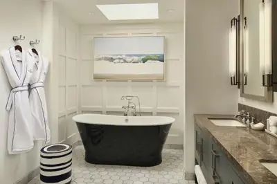 a bathroom with a large bath tub and a sink at Lido House, Autograph Collection in Newport Beach
