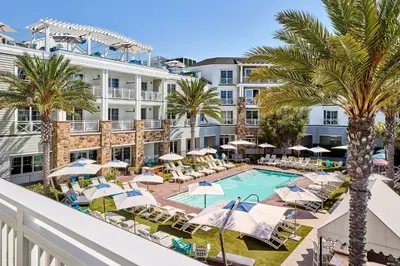 a view of the pool at the resort with chairs and umbrellas at Lido House, Autograph Collection in Newport Beach