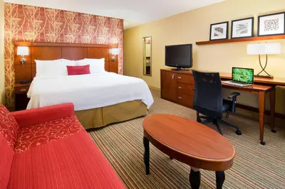 a hotel room with a bed and a desk with a computer at Courtyard Irvine John Wayne Airport/Orange County in Irvine