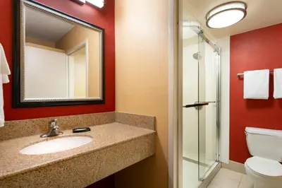 a bathroom with a sink and a toilet and a mirror at Courtyard Irvine John Wayne Airport/Orange County in Irvine