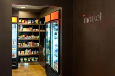 a store with a refrigerator and shelves of food at Courtyard Irvine John Wayne Airport/Orange County in Irvine