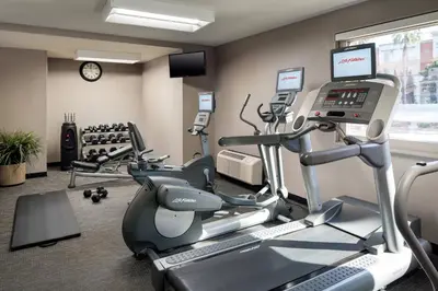 a gym with treadmills and ellipticals in a room at Courtyard Irvine John Wayne Airport/Orange County in Irvine