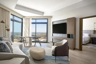 a hotel room with a bed and a tv and a living room at VEA Newport Beach, a Marriott Resort & Spa in Newport Beach