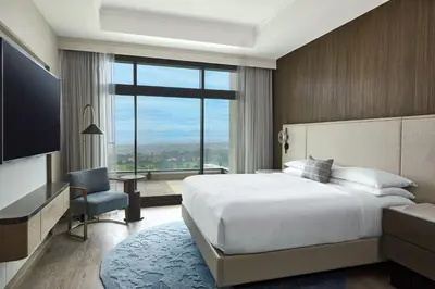 a bedroom with a large bed and a large window at VEA Newport Beach, a Marriott Resort & Spa in Newport Beach