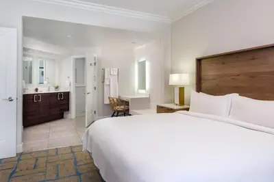 a white bedroom with a large bed and a bathroom at Marriott's Newport Coast Villas in Newport Beach