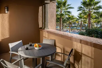 a table and chairs on a balcony with palm trees at Marriott's Newport Coast Villas in Newport Beach