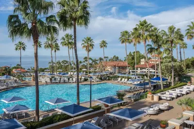 an aerial view of the pool at a resort with palm trees at Marriott's Newport Coast Villas in Newport Beach