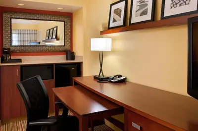 a hotel room with a desk with a lamp on it at Courtyard by Marriott San Diego Sorrento Valley in Sorrento