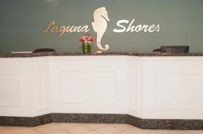 a white counter with a sign that reads laena shore at Laguna Shores Studio Suites in Laguna Beach