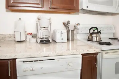 a kitchen counter with a coffee maker on it at Laguna Shores Studio Suites in Laguna Beach