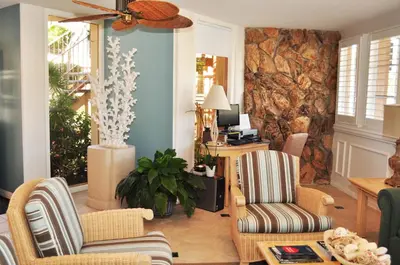 a living room with two chairs and a couch at Laguna Shores Studio Suites in Laguna Beach