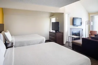 a hotel room with two beds and a flat screen tv at Residence Inn San Diego La Jolla in San Diego
