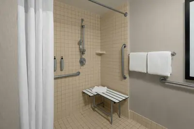 a bathroom with a shower with a bench in it at Residence Inn San Diego La Jolla in San Diego