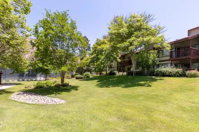 a large yard with trees in front of a building at San Diego Country Estates in Ramona