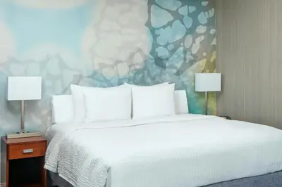 a bedroom with a bed with two lamps and a painting at Courtyard Foothill Ranch Irvine East/Lake Forest in Foothill Ranch