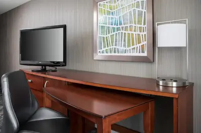a room with a desk with a television and a chair at Courtyard Foothill Ranch Irvine East/Lake Forest in Foothill Ranch