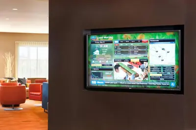 a flat screen tv on a wall in a waiting room at Courtyard Foothill Ranch Irvine East/Lake Forest in Foothill Ranch