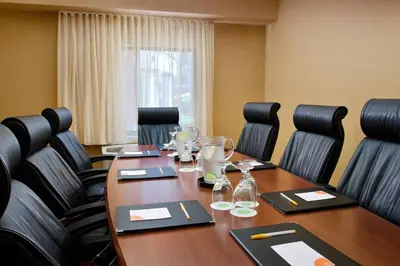 a conference room with a long wooden table and chairs at Courtyard Foothill Ranch Irvine East/Lake Forest in Foothill Ranch
