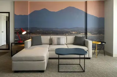 a living room with a couch and a mountain mural at Residence Inn Irvine John Wayne Airport Orange County in Irvine
