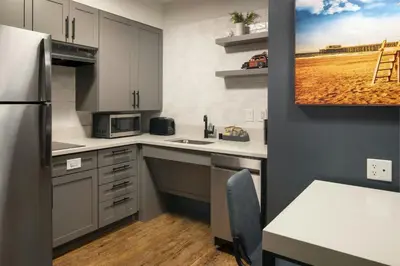 a small kitchen with a sink and a refrigerator at Residence Inn Irvine John Wayne Airport Orange County in Irvine