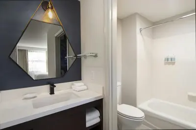 a bathroom with a sink and a toilet and a mirror at Residence Inn Irvine John Wayne Airport Orange County in Irvine