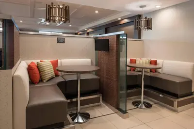 a waiting room with a table and two stools at Residence Inn Irvine John Wayne Airport Orange County in Irvine