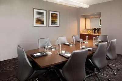 a conference room with a wooden table and chairs at Sonesta Select Laguna Hills Irvine Spectrum in Laguna Hills