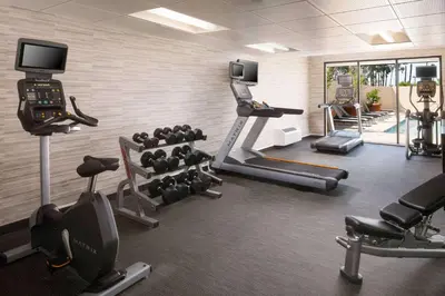 a gym with treadmills and machines in a room at Sonesta Select Laguna Hills Irvine Spectrum in Laguna Hills