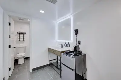 a white bathroom with a sink and a toilet at Hotel Ash&9th in San Diego