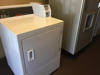 a microwave sitting on top of a counter next to a refrigerator at Chula Vista Inn in Chula Vista
