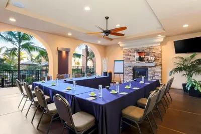 a conference room with tables and chairs and a fireplace at Courtyard San Diego Airport/Liberty Station in San Diego