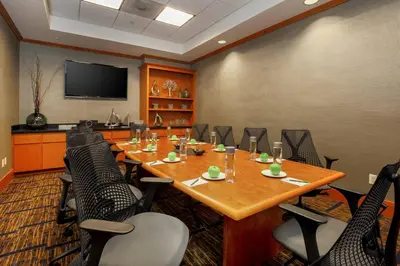 a conference room with a large wooden table and chairs at Courtyard San Diego Airport/Liberty Station in San Diego
