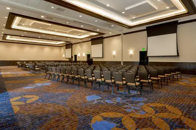 a conference room with a row of chairs and a podium at Courtyard San Diego Airport/Liberty Station in San Diego