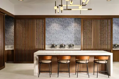a kitchen with a large white counter and bar stools at Courtyard by Marriott San Diego Mission Valley/Hotel Circle in San Diego