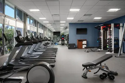 a gym with a row of treadms and machines at Courtyard by Marriott San Diego Mission Valley/Hotel Circle in San Diego