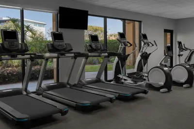 a row of treadmills in a gym with windows at Courtyard by Marriott San Diego Central in San Diego