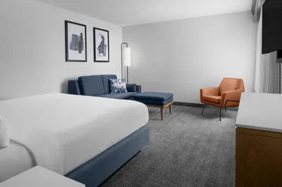 a hotel room with a bed and two chairs at Courtyard by Marriott San Diego Central in San Diego