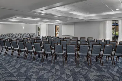 a row of chairs in a room with a screen at Courtyard by Marriott San Diego Central in San Diego