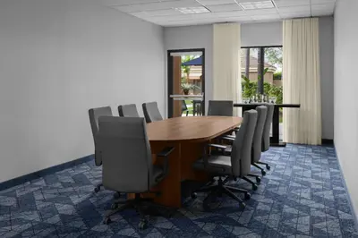 a conference room with a wooden table and chairs at Courtyard by Marriott San Diego Central in San Diego