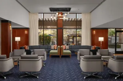 a lobby with a waiting room with couches and chairs at Courtyard by Marriott San Diego Central in San Diego