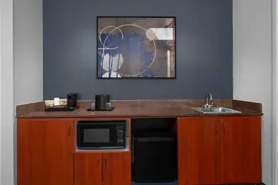 a kitchen with a counter with a microwave and a sink at Courtyard by Marriott San Diego Central in San Diego